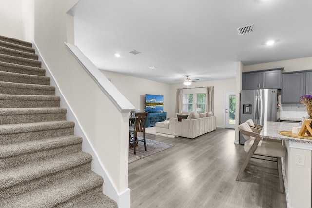 1304 Villalonga Dr, Little Elm, TX 75068 - living room with stairway, light wood-style floors, a ceiling fan, recessed lighting, and baseboards