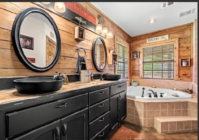 783 County Rd 4420, Whitewright, TX 75491 - bathroom featuring double vanity, a garden tub, and wood walls