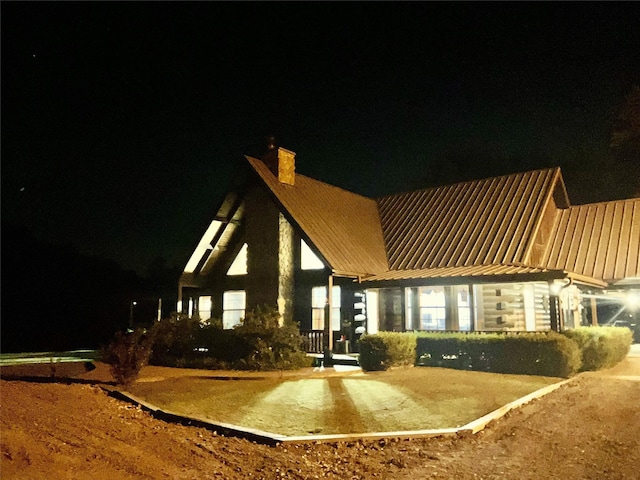 783 County Rd 4420, Whitewright, TX 75491 - back of house at twilight with a chimney and metal roof