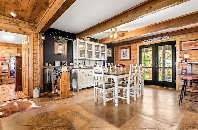 783 County Rd 4420, Whitewright, TX 75491 - dining room with french doors, beamed ceiling, wood walls, ceiling fan, and concrete flooring