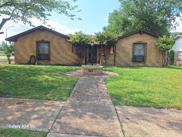 826 E Center St, Duncanville, TX 75116 - view of front of house featuring a front lawn and brick siding