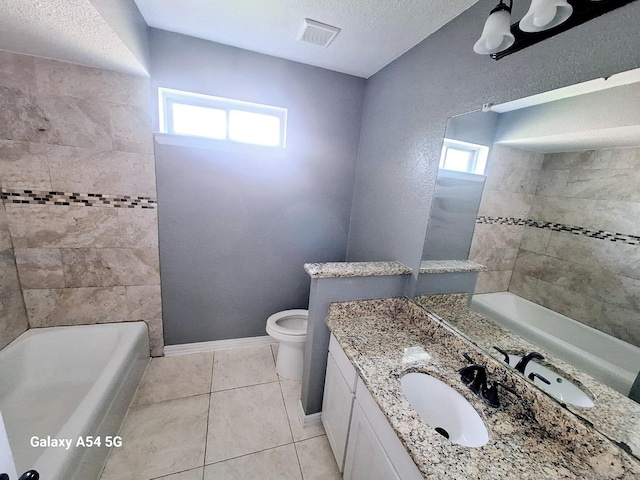 826 E Center St, Duncanville, TX 75116 - full bath featuring healthy amount of natural light, toilet, vanity, tile patterned flooring, and a textured ceiling