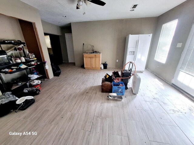 826 E Center St, Duncanville, TX 75116 - living area with a ceiling fan and light wood-style floors