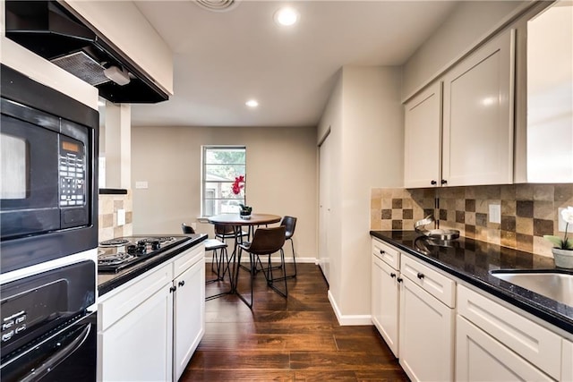 3331 Ruidosa Ave, Dallas, TX 75228 - kitchen with black appliances, dark wood-style floors, backsplash, recessed lighting, and under cabinet range hood