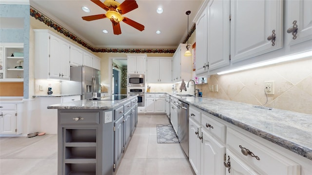 7534 Wellesley Ave, Garland, TX 75044 - kitchen with appliances with stainless steel finishes, a sink, white cabinets, gray cabinetry, and crown molding
