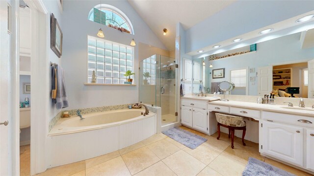 7534 Wellesley Ave, Garland, TX 75044 - full bath with a shower stall, double vanity, plenty of natural light, a bath, and high vaulted ceiling