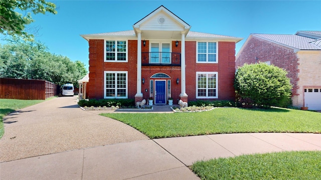 7534 Wellesley Ave, Garland, TX 75044 - neoclassical home featuring a balcony, driveway, and brick siding