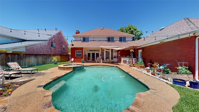 7534 Wellesley Ave, Garland, TX 75044 - view of pool featuring a patio, a fenced backyard, a pool with connected hot tub, and french doors