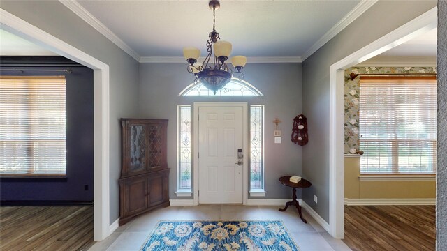 7534 Wellesley Ave, Garland, TX 75044 - entryway with a chandelier, ornamental molding, and baseboards