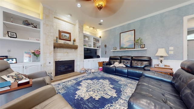 7534 Wellesley Ave, Garland, TX 75044 - living room featuring built in shelves, crown molding, a wainscoted wall, a large fireplace, and recessed lighting