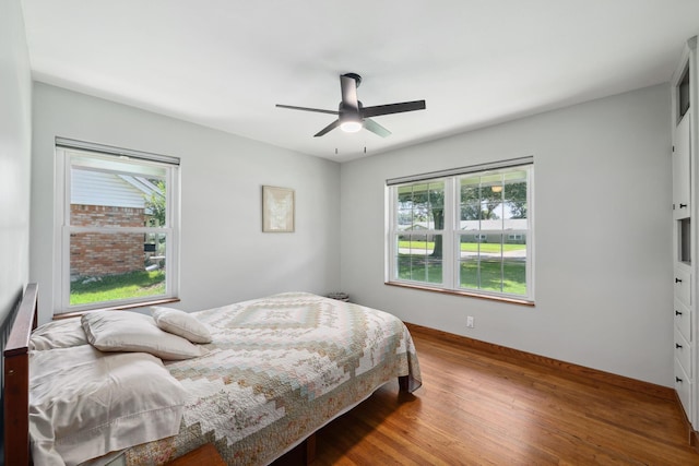 1209 Redbud Dr, Arlington, TX 76012 - bedroom with wood finished floors, a ceiling fan, and baseboards