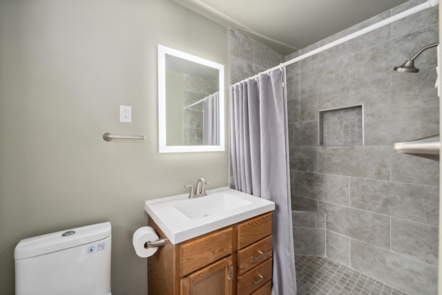 1209 Redbud Dr, Arlington, TX 76012 - bathroom with vanity, tiled shower, and toilet