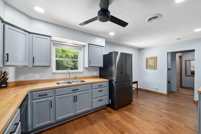 1209 Redbud Dr, Arlington, TX 76012 - kitchen with wooden counters, a sink, freestanding refrigerator, ceiling fan, and dark wood finished floors