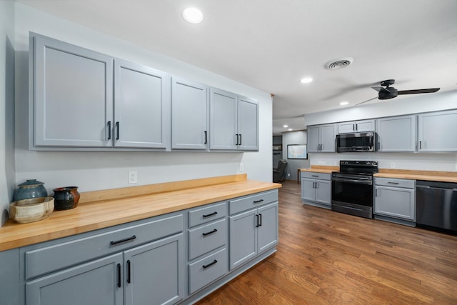 1209 Redbud Dr, Arlington, TX 76012 - kitchen with butcher block counters, stainless steel appliances, gray cabinets, recessed lighting, and dark wood-style floors