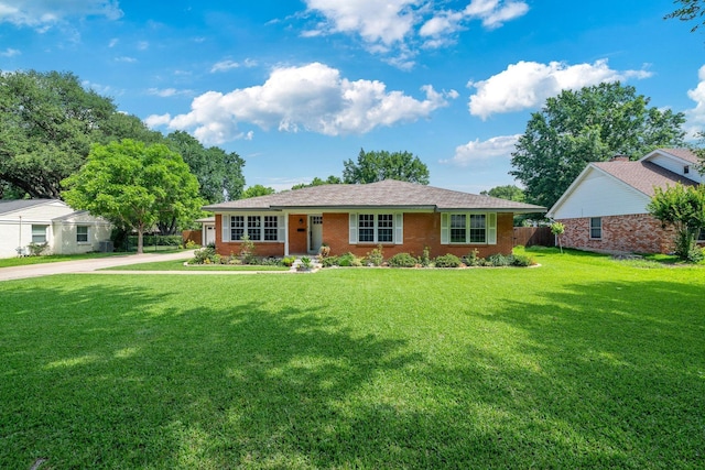 1209 Redbud Dr, Arlington, TX 76012 - ranch-style house featuring a front yard, brick siding, and concrete driveway