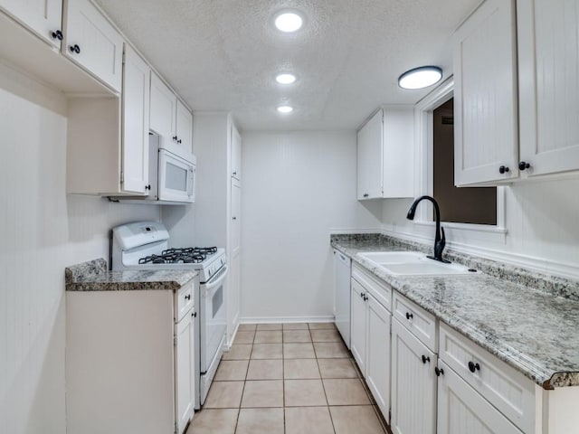 1429 Meadowcrest Dr, Plano, TX 75075 - kitchen featuring white appliances, a sink, a textured ceiling, white cabinets, and light tile patterned floors