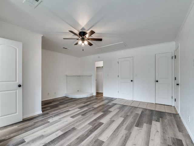 1429 Meadowcrest Dr, Plano, TX 75075 - unfurnished bedroom featuring attic access, light wood-style flooring, crown molding, ceiling fan, and baseboards
