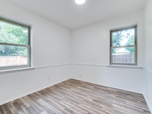1429 Meadowcrest Dr, Plano, TX 75075 - empty room featuring plenty of natural light, wood finished floors, and baseboards