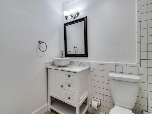 1429 Meadowcrest Dr, Plano, TX 75075 - bathroom featuring vanity, ornamental molding, tile walls, toilet, and wainscoting