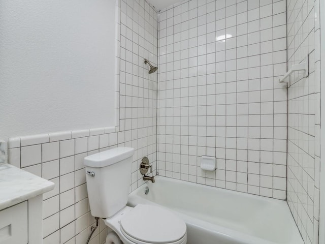 1429 Meadowcrest Dr, Plano, TX 75075 - bathroom featuring tile walls, toilet, vanity, tub / shower combination, and a wainscoted wall