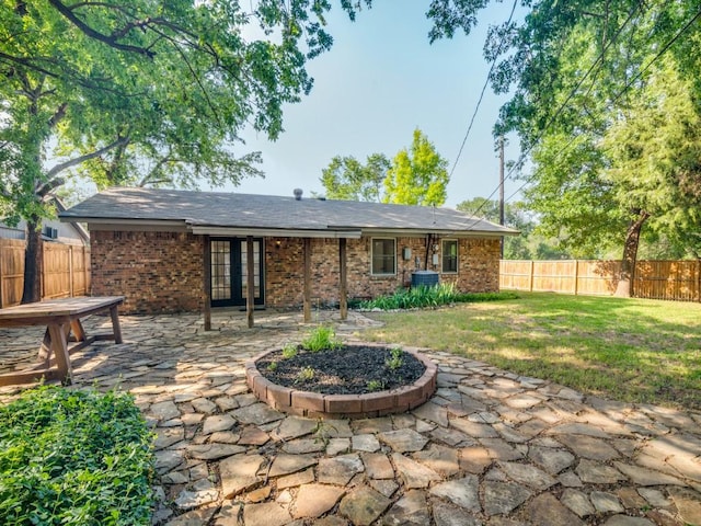 1429 Meadowcrest Dr, Plano, TX 75075 - back of property with french doors, a patio area, and brick siding