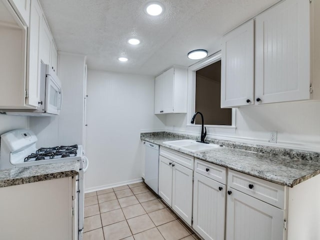 1429 Meadowcrest Dr, Plano, TX 75075 - kitchen featuring white appliances, a sink, a textured ceiling, white cabinetry, and light tile patterned flooring