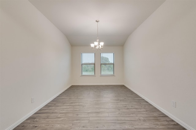 6100 Fall Creek Ln, Fort Worth, TX 76123 - spare room featuring a chandelier, wood finished floors, vaulted ceiling, and baseboards
