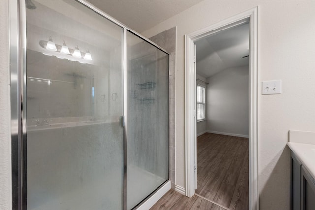 6100 Fall Creek Ln, Fort Worth, TX 76123 - full bath featuring vanity, a shower stall, vaulted ceiling, wood finished floors, and baseboards