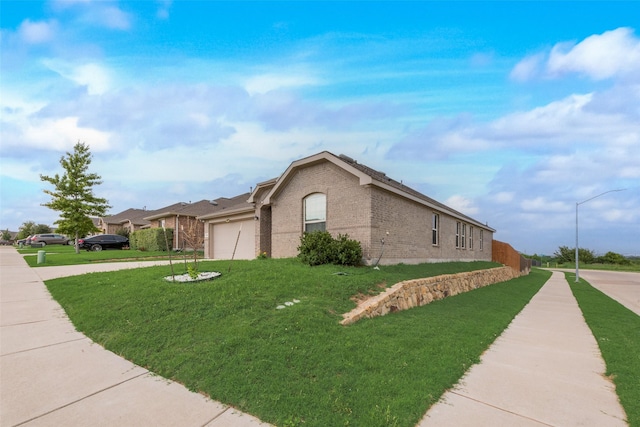 6100 Fall Creek Ln, Fort Worth, TX 76123 - view of property exterior featuring brick siding, an attached garage, a lawn, and driveway