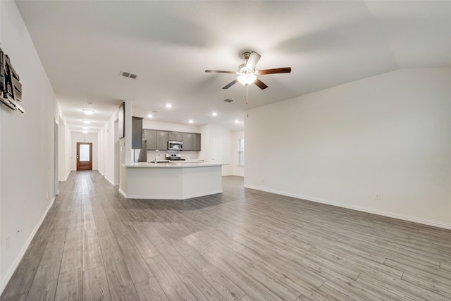 6100 Fall Creek Ln, Fort Worth, TX 76123 - unfurnished living room with ceiling fan, light wood finished floors, baseboards, a sink, and recessed lighting