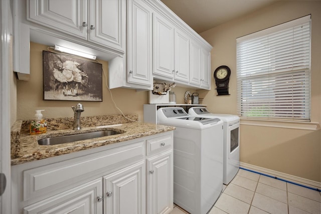 5505 Moorewood Dr, Arlington, TX 76017 - laundry room with independent washer and dryer, cabinet space, light tile patterned flooring, and baseboards