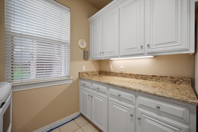 5505 Moorewood Dr, Arlington, TX 76017 - kitchen with white cabinetry, baseboards, light tile patterned flooring, and light stone counters