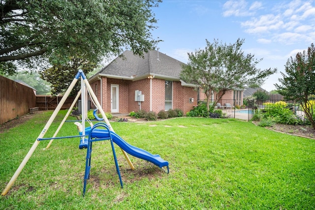 5505 Moorewood Dr, Arlington, TX 76017 - back of property with a playground, brick siding, and roof with shingles