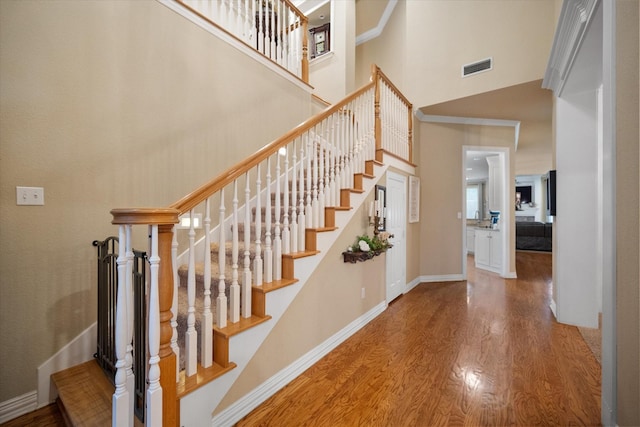 5505 Moorewood Dr, Arlington, TX 76017 - stairs featuring wood finished floors, baseboards, and a towering ceiling