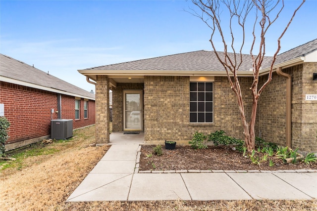 12701 Seagull Way, Frisco, TX 75036 - view of front of home featuring central AC, brick siding, and a shingled roof