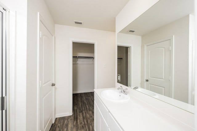 234 Backlash Dr, Gun Barrel City, TX 75156 - bathroom with vanity, wood finished floors, baseboards, and a walk in closet
