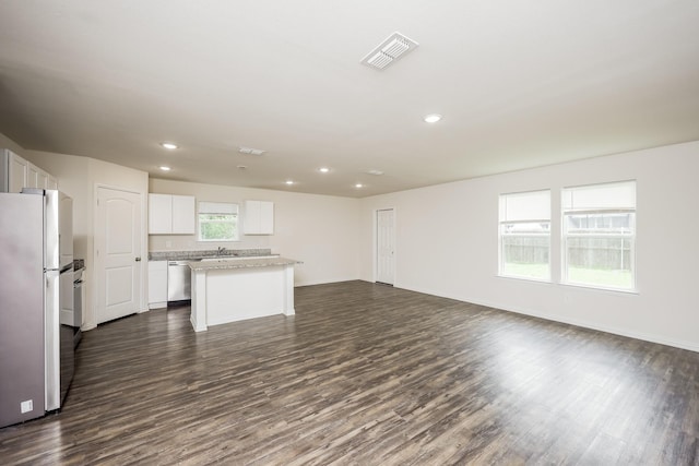 234 Backlash Dr, Gun Barrel City, TX 75156 - kitchen featuring freestanding refrigerator, open floor plan, dark wood-style floors, a center island, and white cabinetry