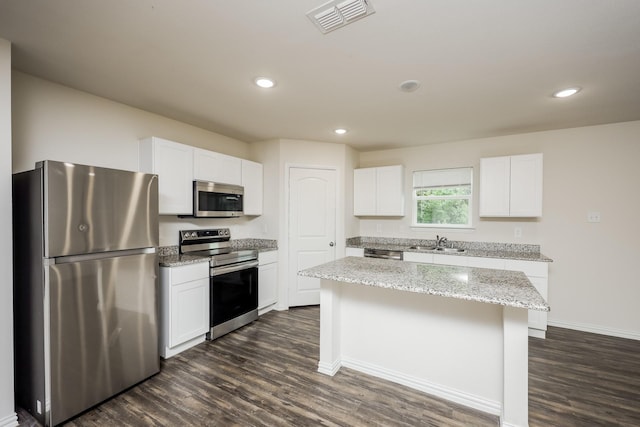 234 Backlash Dr, Gun Barrel City, TX 75156 - kitchen featuring appliances with stainless steel finishes, dark wood-style floors, a kitchen island, white cabinets, and baseboards