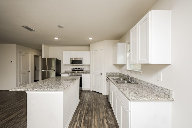 234 Backlash Dr, Gun Barrel City, TX 75156 - kitchen featuring appliances with stainless steel finishes, a sink, dark wood finished floors, a kitchen island, and white cabinetry