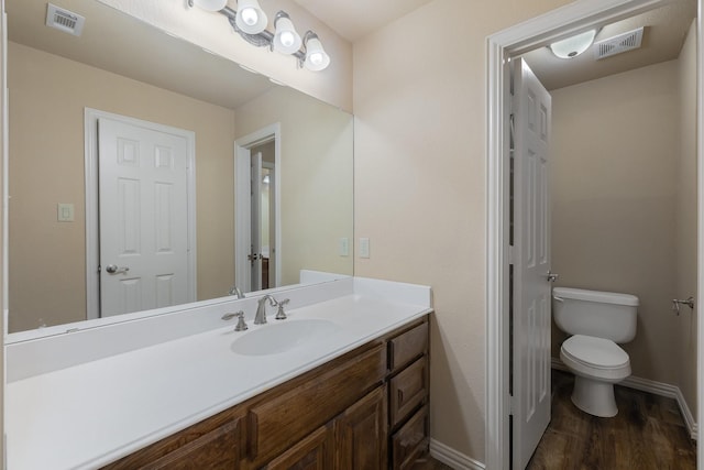 18 Oxford Way, Allen, TX 75002 - bathroom with toilet, vanity, baseboards, and wood finished floors