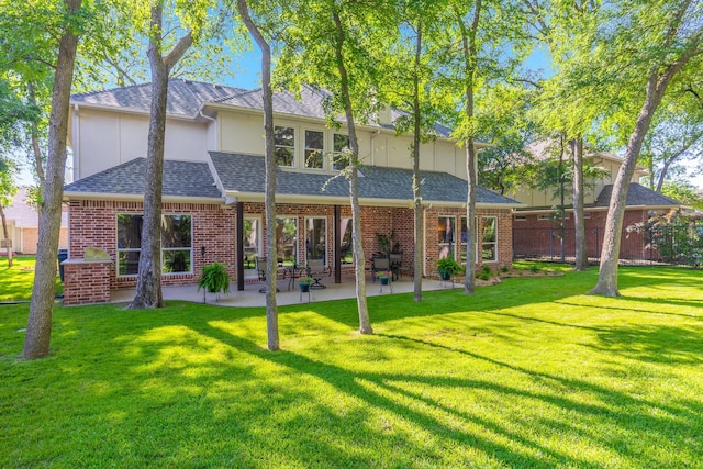 18 Oxford Way, Allen, TX 75002 - rear view of house featuring a shingled roof, brick siding, a patio area, and board and batten siding