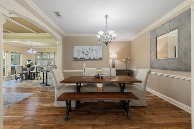 18 Oxford Way, Allen, TX 75002 - dining room featuring a chandelier, crown molding, hardwood / wood-style floors, arched walkways, and baseboards