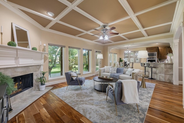 18 Oxford Way, Allen, TX 75002 - living room featuring coffered ceiling, a fireplace, a ceiling fan, crown molding, and wood finished floors