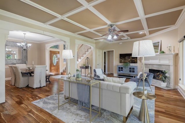 18 Oxford Way, Allen, TX 75002 - living area with stairway, coffered ceiling, wood finished floors, a tiled fireplace, and ceiling fan