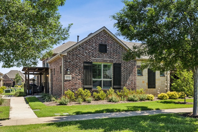 3900 Dalea Dr, Prosper, TX 75078 - view of front of property featuring a pergola, brick siding, a front lawn, and roof with shingles