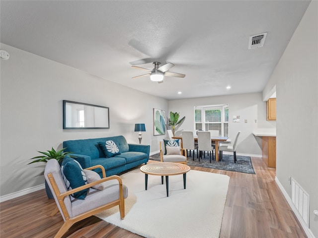 2036 Pearl Ln, Irving, TX 75060 - living room with a ceiling fan, light wood finished floors, and baseboards