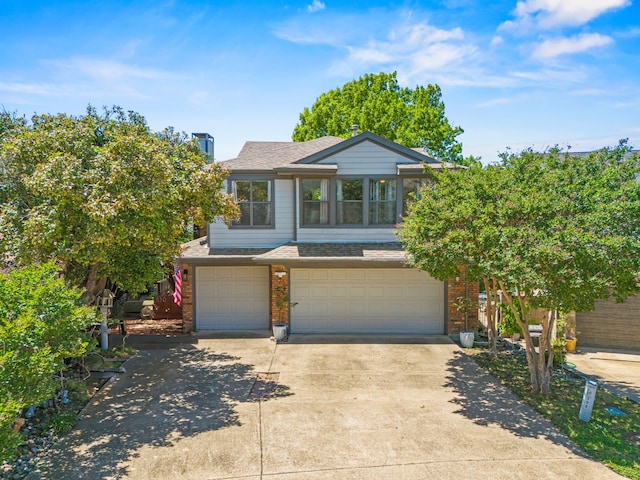 510 Columbia Dr, Rockwall, TX 75032 - view of front facade with brick siding, a garage, driveway, and roof with shingles