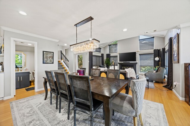 510 Columbia Dr, Rockwall, TX 75032 - dining space featuring crown molding, stairs, a chandelier, light wood-style flooring, and recessed lighting