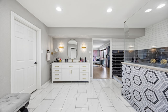 510 Columbia Dr, Rockwall, TX 75032 - bathroom with vanity, marble look tile flooring, recessed lighting, and tiled shower