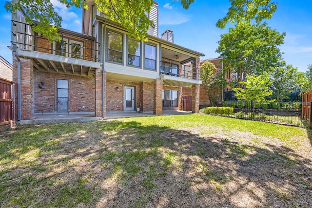 510 Columbia Dr, Rockwall, TX 75032 - rear view of property featuring a balcony, brick siding, a patio, and a chimney